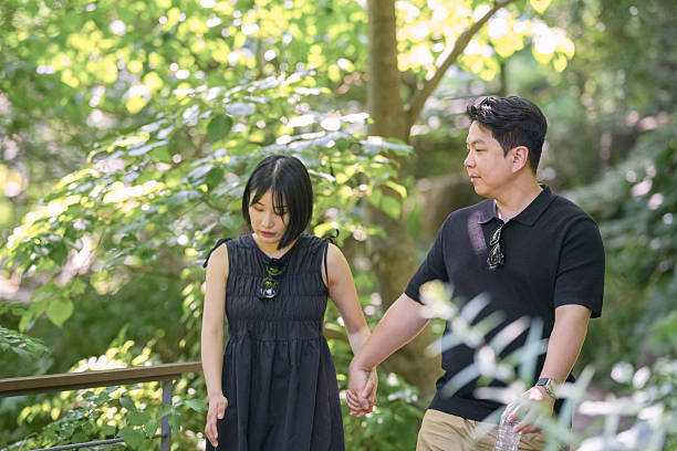 istock A man and woman are walking in a forest, holding hands 2249910869