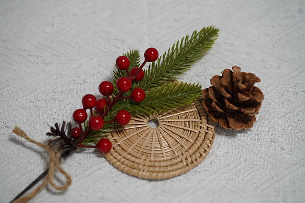 istock Decorative Arrangement with Pine Cone, Red Berries, and Green Foliage on a Light Textile Background for Holiday and Seasonal Themes 2249910891