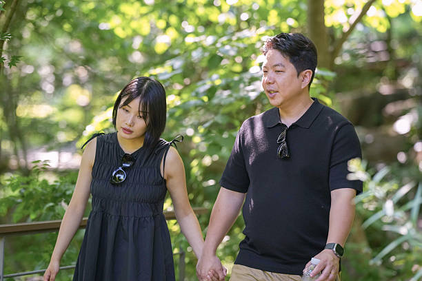 istock A man and a woman are walking in a forest 2249910933