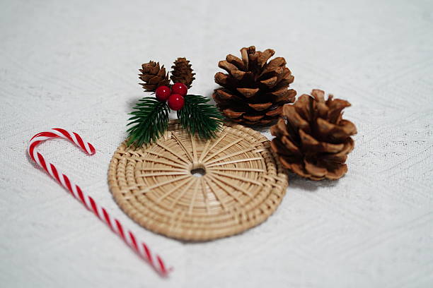 istock Festive Winter Decorations Featuring Pine Cones, Holly Berries, and a Candy Cane on a Textured White Background 2249910961