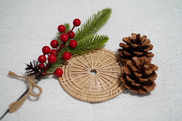 istock Natural elements for festive decor featuring pinecones, greenery, and red berries arranged artistically on a textured background for holiday inspiration 2249911053