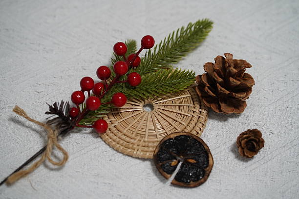 istock Rustic arrangement featuring pinecones, evergreen sprigs, bright red berries, and decorative dried fruit on a textured background for seasonal decor 2249911070