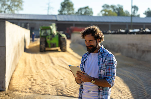 istock Farmer in front of tractor on farm 2249911184