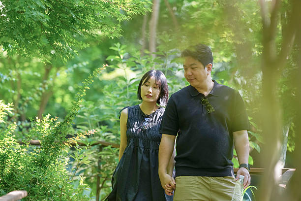 istock A man and a woman are walking in a park 2249911233