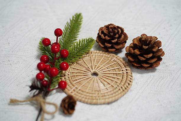 istock Rustic holiday decoration featuring pinecones, red berries, and green leaves arranged artfully on a textured white background for seasonal warmth 2249911270