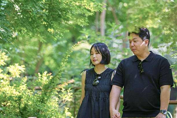 istock A man and a woman are walking in a park 2249911281