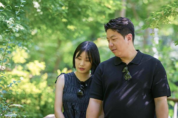 istock A man and a woman are standing in a forest 2249911342