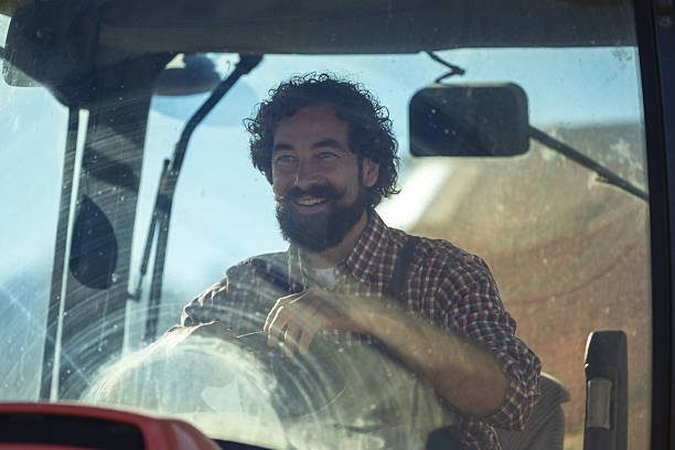 istock Farmer driving tractor in field 2249911543