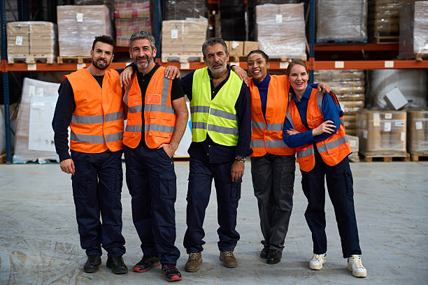 istock Group of warehouse workers smiling, working as a team 2249913724