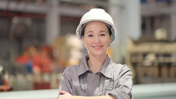 istock Female engineer or technicians professional with experience, expertise and technical skills in their work in production line at industrial manufacturing, smile standing and arms crossed on factory background have production line and modern machinery. 2249914550
