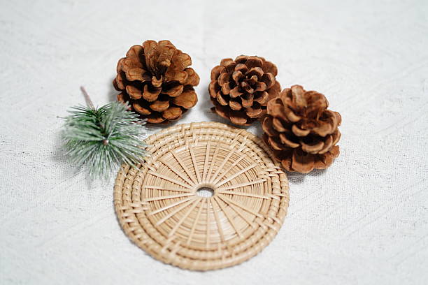 istock Natural Pine Cones and Decorative Greenery on Rustic Woven Mat for Seasonal Home Decor, Craft Projects and Creative Arrangements 2249915156