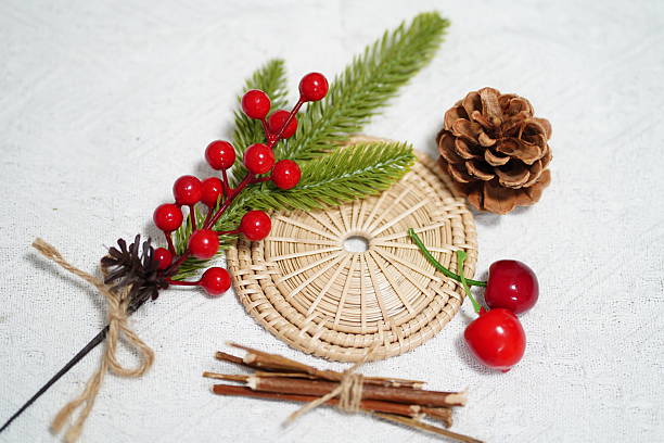 istock Natural Decor Elements Featuring Pine Sprigs, Red Berries, Pine Cone, Cherry Fruits, and Natural Weaving on White Background for Festive Crafts 2249915566