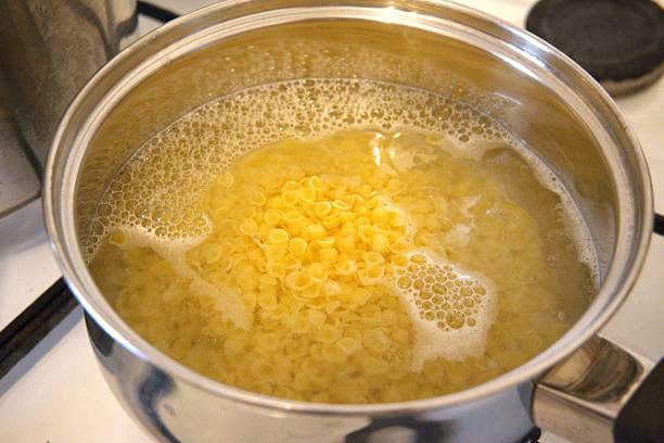 istock Small Shell Pasta Boiling in Water in Cooking Pan in Close-Up 2249915979