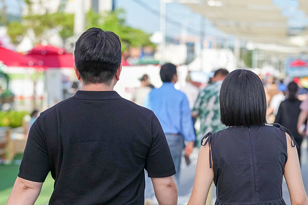 A man and woman walking together in a crowded area