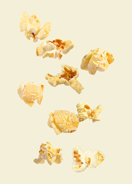 istock Tasty fresh popcorn flying on beige background 2249916826