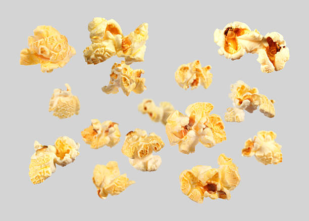 istock Tasty fresh popcorn flying on grey background 2249916896