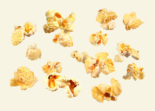 istock Tasty fresh popcorn flying on beige background 2249917043