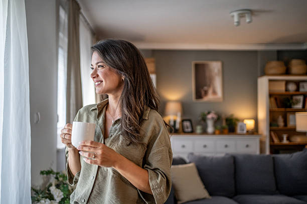 istock Woman enjoying morning coffee looking out window 2249917077