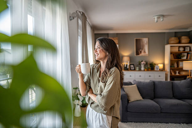 istock Woman enjoying morning coffee looking out window 2249917249