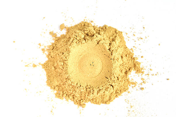Dry ground mustard powder isolated on white background.