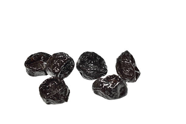 A prune is a dried plum isolated on a white background.