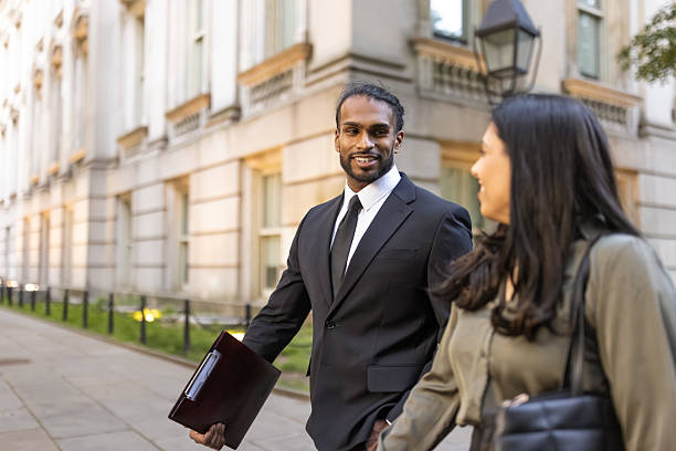 istock Professional Colleagues Walking and Talking Outdoors 2249921339