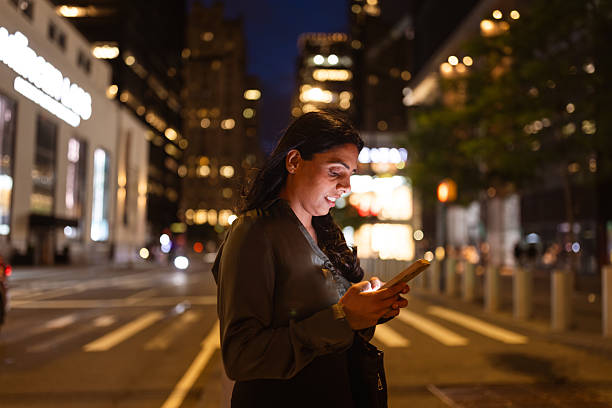 istock Evening City Browsing by Young Woman 2249921463