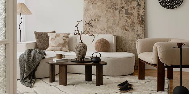 istock Bright neutral living space with textured pillows, soft boucle seating, and a ceramic vase as the focal point. 2249921906