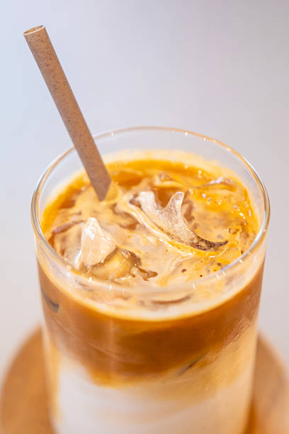 An iced caffe latte coffee using an eco-friendly straw from a specialty coffee shop