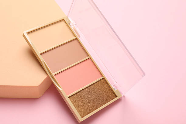 istock Colorful eyeshadow palette and podium on pink background, closeup. Space for text 2249926091