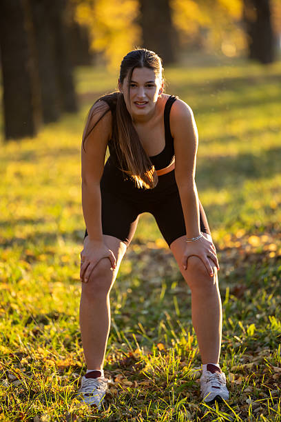 istock Young woman resting after a run in a park 2249929229