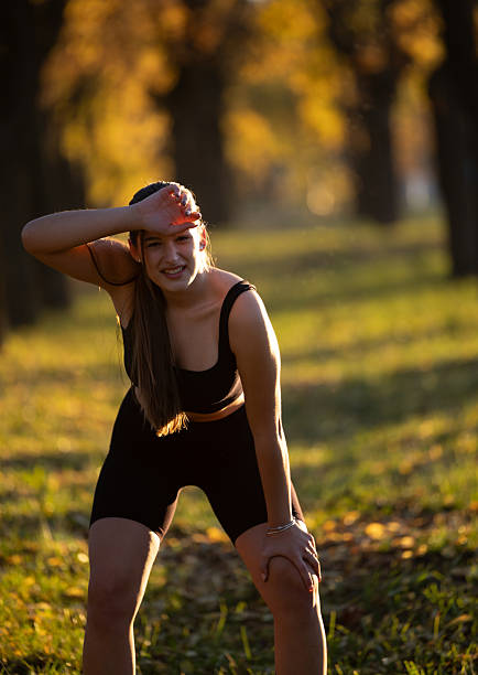 Young woman resting after a run in a park