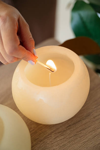 istock Woman lighting a candle for aromatherapy session creating calm atmosphere 2249929926