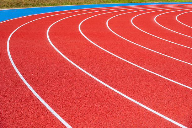 istock Empty running tracks at an outdoor athletics stadium featuring distinctive white lines and curves 2249930389