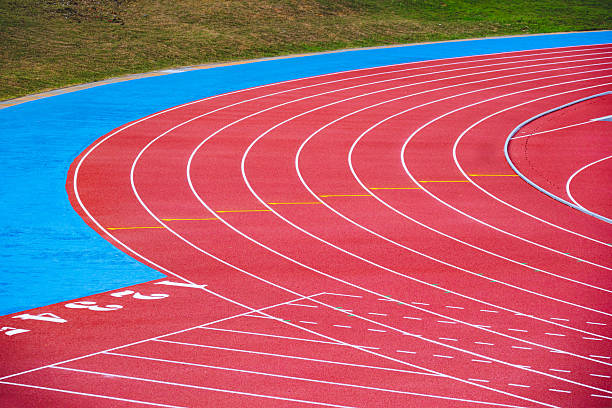 istock Empty running tracks at an outdoor athletics stadium featuring distinctive white lines and curves 2249930426