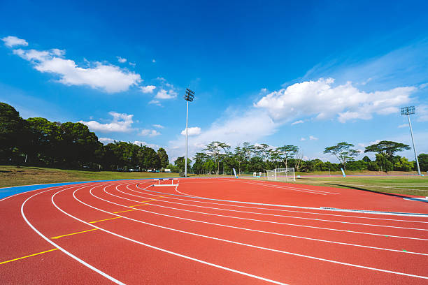 istock Empty running tracks at an outdoor athletics stadium featuring distinctive white lines and curves 2249930441
