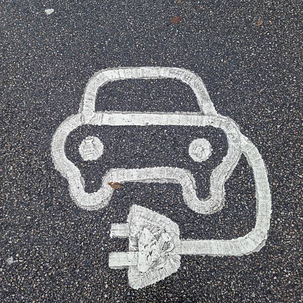 istock Electric Vehicle Charging Symbol Painted on Asphalt Parking Surface 2249930963