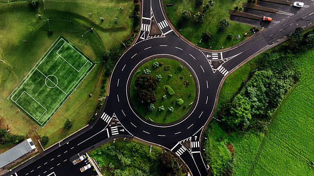 istock Aerial view of a circular intersection surrounded by lush greenery 2249932682