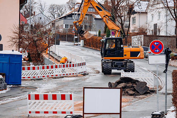 istock Excavator Working at Winter Road Repair Site 2249933013