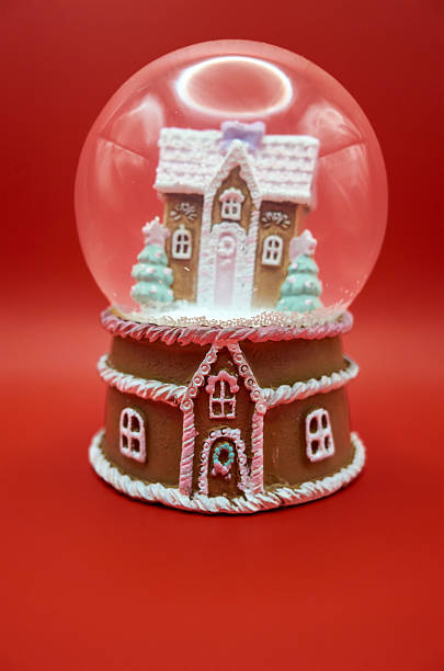 istock Miniature gingerbread cottage in transparent sphere with holiday details 2249934115