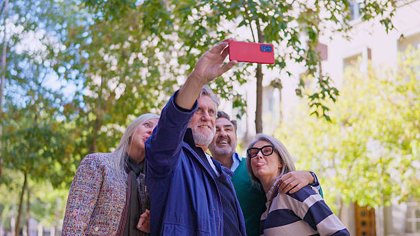 istock Mature friends taking selfie outdoors having fun together 2249935770