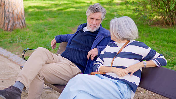 istock Senior couple talking together on park bench 2249935830