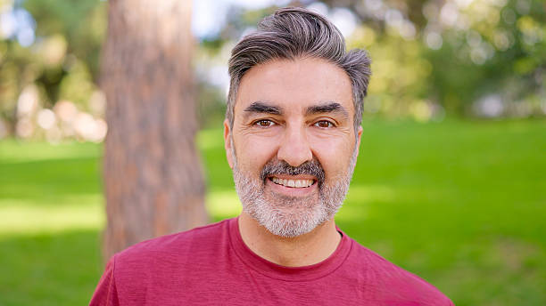 istock Mature man smiling at camera in park 2249935845