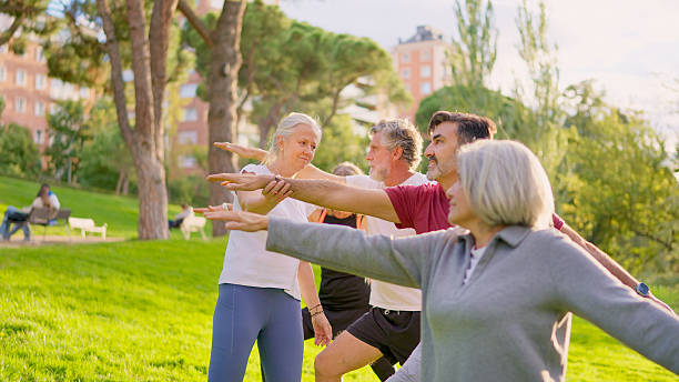 istock Senior adults enjoying group yoga class in park 2249935897