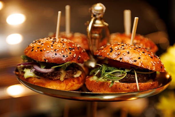 istock Gourmet burgers with sesame buns on serving tray 2249937071
