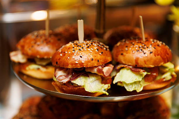 istock Mini gourmet burgers with lettuce and bacon on tray 2249937128