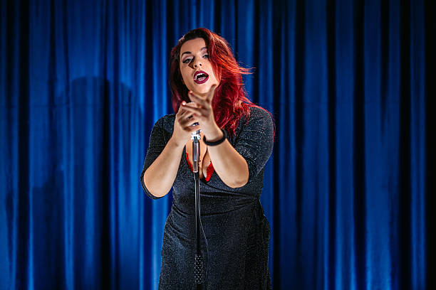 istock Mid-Adult Woman Singing On Stage 2249938862