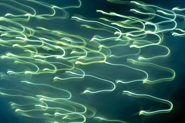 Abstract, swirling, distorted waves, yellow and turquoise, magical neon lights on a blue background. Energy flows.