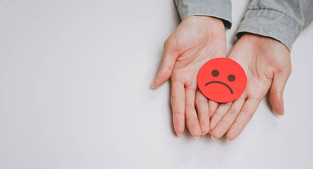 istock Sad face icon hands human emotion expression negative feeling isolated white background palm person symbol unhappy gesture close up skin adult one person holding isolated object negative emotion 2249940050