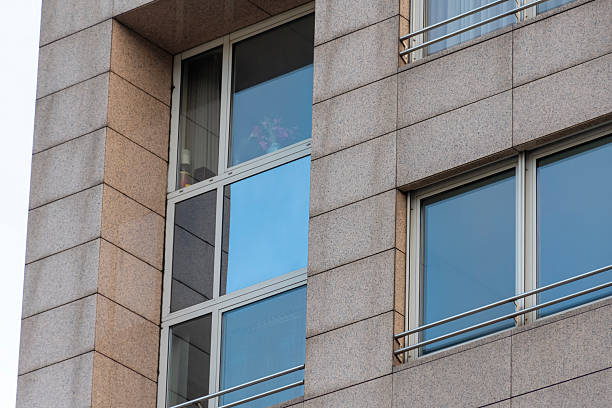 istock Modern office building facade with large windows, light stone panels and smooth geometric architectural lines 2249941073